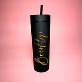 Black tumbler with 'Brooklyn' in gold on a pink gradient background