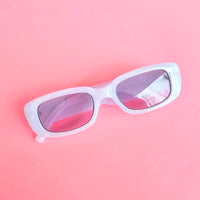 Pearl white bride sunglasses with silver BRIDE lettering and light grey lenses