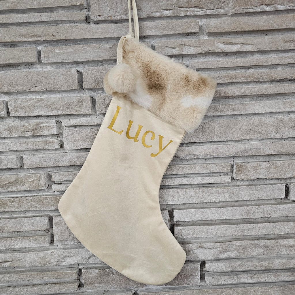 Luxury ivory Christmas stocking with tan and white faux fur cuff and metallic gold personalized name, handmade in a small Ohio shop