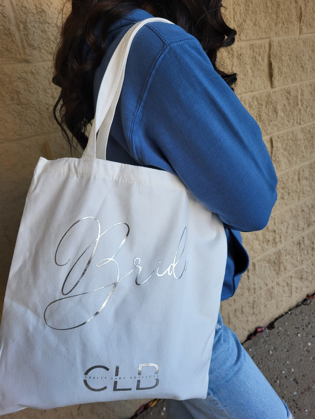 White bag with 'CLB' branding on a textured surface