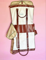White and brown foldable weekender travel bag with leather-style straps, perfect for brides on the go.