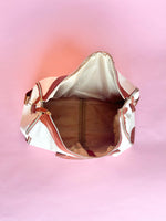 White and brown foldable weekender travel bag with leather-style straps, perfect for brides on the go.