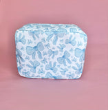White makeup bag with an all-over light blue bow pattern, featuring a rectangular shape and zippered closure — perfect for brides and travel use.