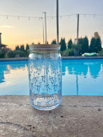 Clear 16oz glass cup with bamboo lid and straw featuring a blue bow pattern, perfect for iced coffee and bridal gifts.