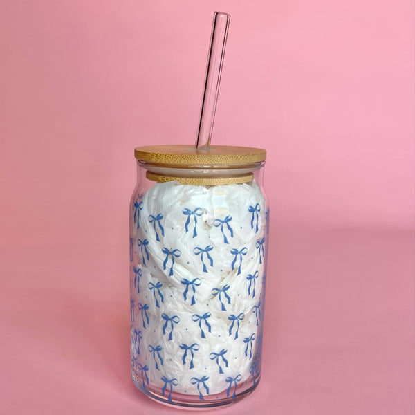 Clear 16oz glass cup with bamboo lid and straw featuring a blue bow pattern, perfect for iced coffee and bridal gifts.