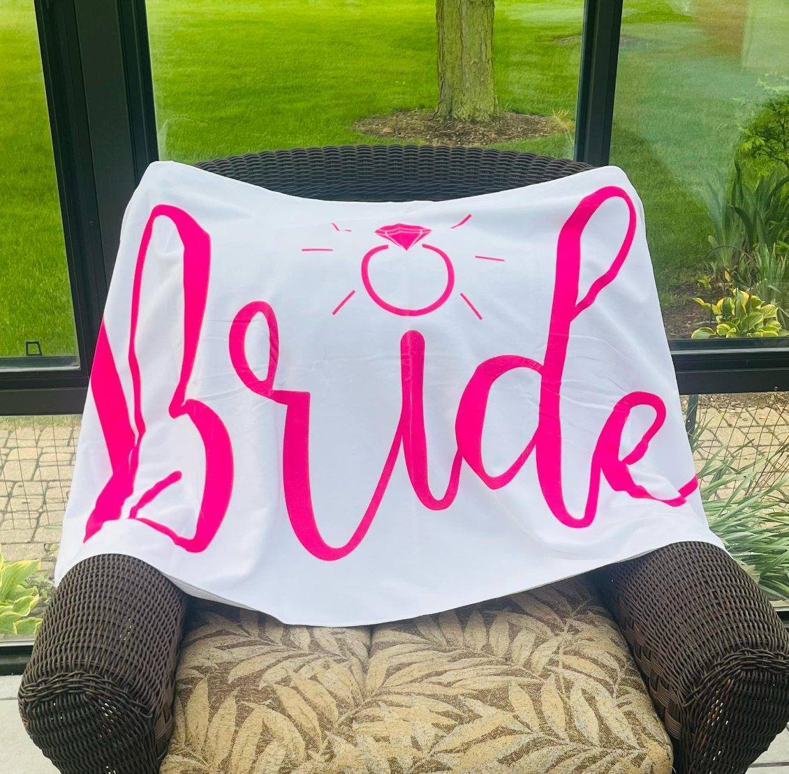White microfiber towel with bold pink 'Bride' lettering and diamond ring graphic.