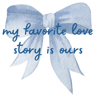 White t-shirt with a large blue bow and the phrase “my favorite love story is ours”—perfect for brides, wives, and romantic occasions.