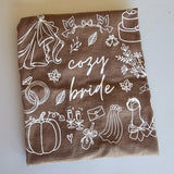 Cozy Bride and Cozy Wife fall graphic t-shirts in soft cotton, perfect for brides and wives to celebrate autumn, wedding planning, and wife life.