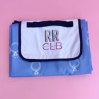 Foldable picnic mat with blue engagement ring print, white inner lining, and personalized flap—perfect for brides, wives, or bridal party outings.