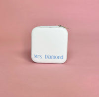 White personalized travel jewelry case open to display organized earrings, rings, and necklaces; compact design perfect for brides and travel.