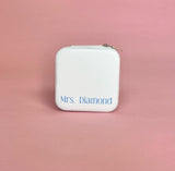White personalized travel jewelry case open to display organized earrings, rings, and necklaces; compact design perfect for brides and travel.