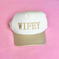 Tan and white trucker hat with embroidered “WIFEY” lettering on the front, a stylish accessory for brides and wives.