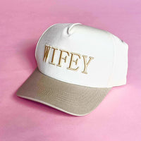 Tan and white trucker hat with embroidered “WIFEY” lettering on the front, a stylish accessory for brides and wives.
