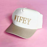 Tan and white trucker hat with embroidered “WIFEY” lettering on the front, a stylish accessory for brides and wives.