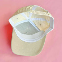 Tan and white trucker hat with embroidered “WIFEY” lettering on the front, a stylish accessory for brides and wives.