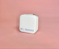 White personalized travel jewelry case open to display organized earrings, rings, and necklaces; compact design perfect for brides and travel.