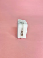 White personalized travel jewelry case open to display organized earrings, rings, and necklaces; compact design perfect for brides and travel.