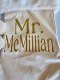 Detail shot showing metallic gold HTV vinyl name on ivory stocking with plush tan and white faux fur cuff
