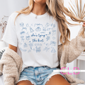 White t-shirt with “She’s Tying the Knot” printed in blue lettering, surrounded by delicate wedding-themed doodles like rings, bows, swans, gifts, and flowers. Ideal for brides-to-be.