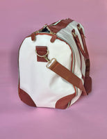 White and brown foldable weekender travel bag with leather-style straps, perfect for brides on the go.