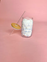 Clear glass cup with bamboo lid and straw featuring blue “She’s Tying the Knot” text and wedding doodles, perfect for brides and iced coffee lovers.
