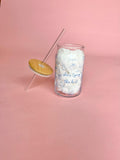 Clear glass cup with bamboo lid and straw featuring blue “She’s Tying the Knot” text and wedding doodles, perfect for brides and iced coffee lovers.