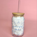 Clear glass cup with bamboo lid and straw featuring blue “She’s Tying the Knot” text and wedding doodles, perfect for brides and iced coffee lovers.