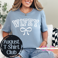Woman wearing a light blue graphic t-shirt with the word “WIFEY” and a white bow design, styled casually with ripped jeans — perfect for brides and wives.