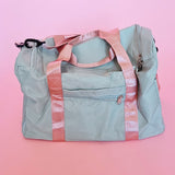Sage green personalized duffel bag with rose gold foil personalization and mauve handles, ideal for brides, honeymoons, and weekend trips