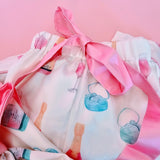 White and pink bridal pajamas with champagne bottle and ring pattern and pink bow