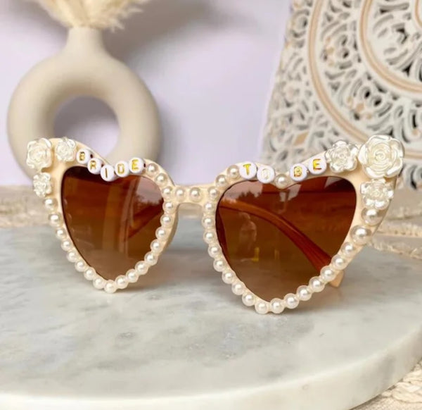 bride-to-be sunglasses, heart-shaped bridal sunglasses, off-white bride sunglasses, pearl and rose sunglasses, wedding sunglasses, fall bridal accessories, neutral themed wedding accessories, bridal party sunglasses, bride sunglasses for fall weddings, bridal shower sunglasses.