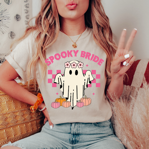 spooky bride tee, Halloween bride shirt, tan spooky bride t-shirt, cute ghost and pumpkin shirt, pink font bride tee, fall bridal shirts, spooky bridal apparel, Halloween wedding tee, spooky bride collection, fun bride t-shirt, Halloween-themed bridal wear