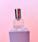 Clear glass mini roller ball perfume bottle with silver lid, ideal for brides to carry wedding day perfume in a purse or bridal bag