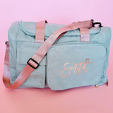 Personalized sage green carry-all duffel bag with mauve handles and rose gold foil name, perfect for travel, honeymoon, and everyday use