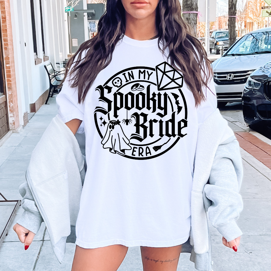 In My Bride Era tee, bride pullover sweatshirt, white bride top, bridal ghost and bats design, black writing bride shirt, cute bride apparel, bridal shower outfit, bachelorette party sweatshirt, stylish bride to be clothing, wedding preparation wear, match with black future mrs sunglasses