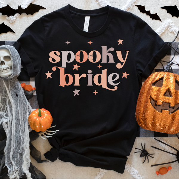 Spooky Bride tee, black Halloween bride shirt, retro bride t-shirt, fall bride apparel, Halloween bride top, colorful spooky bride tee, spooky bride collection, bridal party Halloween shirt, black bride earrings match, Future Mrs. sunglasses pairing, Halloween-themed bridal wear