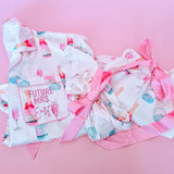 White and pink bridal pajamas with champagne bottles and ring print, perfect for wedding morning and engagement photos