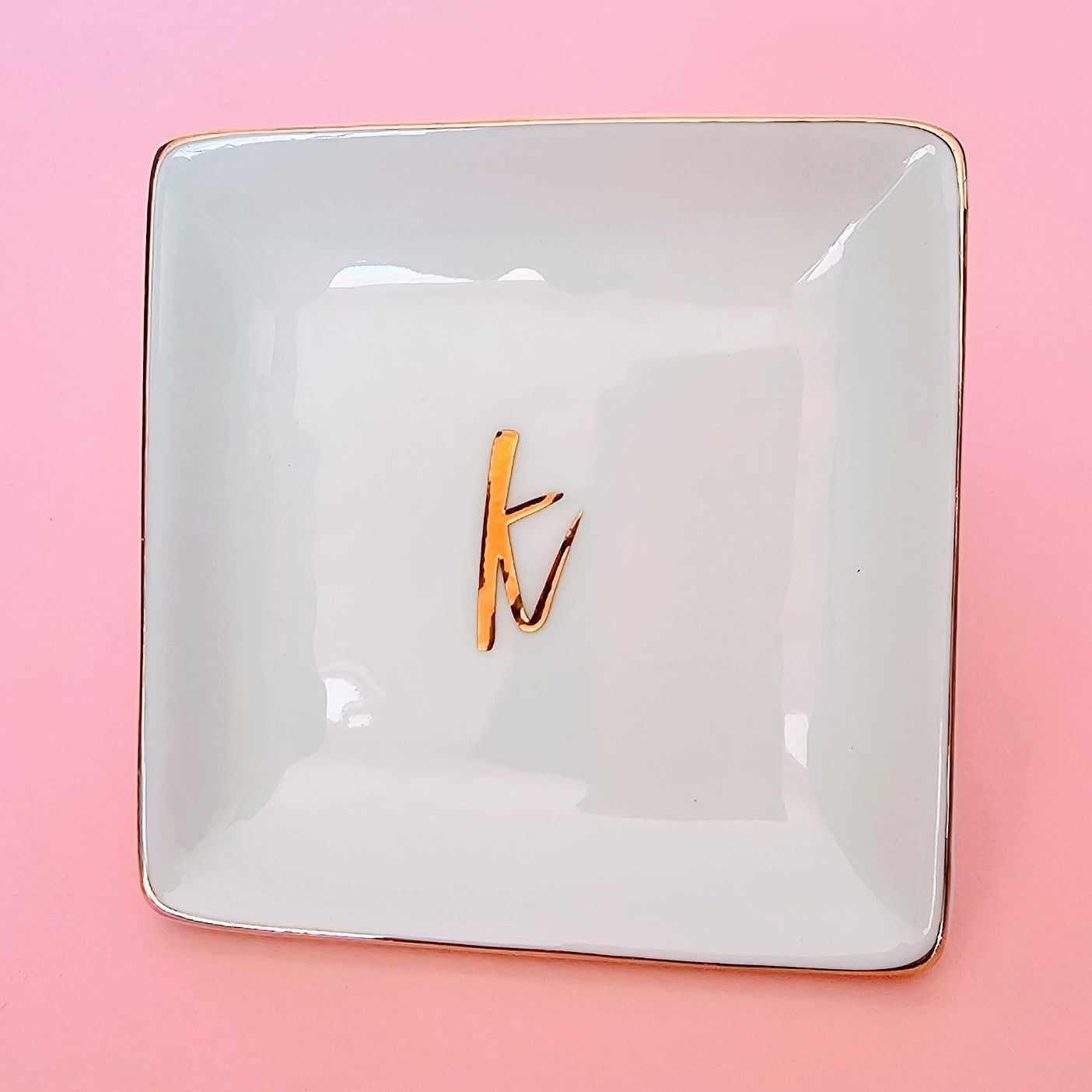 White ceramic trinket tray ring dish with gold trim and gold letter monogram, perfect for engagement and wedding day jewelry